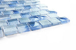 Crystal Aqua Stromboli Petra Blue glass mosaic tile installed on a bathroom shower wall with rich blue tones and reflective glass surfaces.