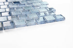Crystal Aqua Stromboli Pronto Blue glass mosaic tile installed on a bathroom shower wall with rich blue tones and reflective glass surfaces.