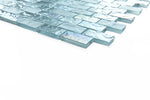 Crystal Aqua Soho Green 1x2 glass mosaic tile installed on a bathroom shower wall with blue-green tones and reflective glass surfaces.