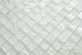 Crystal Aqua Soho White 1x1 glass mosaic tile installed on a bathroom shower wall with clean white tones and reflective glass surfaces.