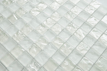 Crystal Aqua Soho White 1x1 glass mosaic tile installed on a bathroom shower wall with clean white tones and reflective glass surfaces.