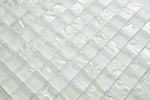 Crystal Aqua Soho White 1x1 glass mosaic tile installed on a bathroom shower wall with clean white tones and reflective glass surfaces.