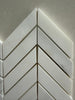 White marble chevron mosaic tile used on a luxury shower wall installation