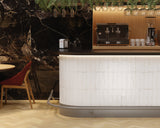 Dune Agadir Niebla Bright porcelain wall tile installed as a kitchen backsplash