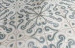 Dune Atlantique Josselin 8x8 decorative porcelain tile featuring an artisan-inspired pattern in a decorative floor installation