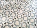 European-inspired decorative porcelain tile floor featuring intricate blue and white motifs