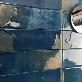 Glossy blue porcelain tile installed as a kitchen backsplash