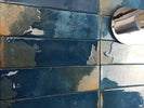 Glossy blue porcelain tile installed as a kitchen backsplash
