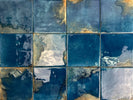 Mediterranean-inspired glazed porcelain backsplash in deep ocean-blue tones

