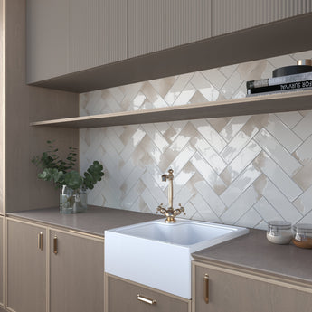 Glossy ivory porcelain tile installed as a kitchen backsplash