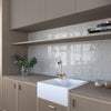 Glossy ivory porcelain tile creating a bright decorative feature wall
