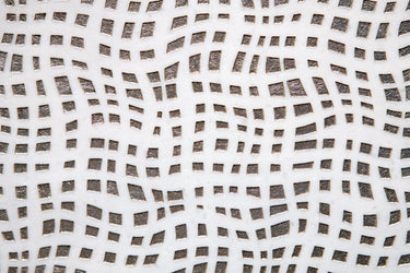 Close-up of textured white marble tile showing layered surface detail