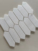 Close up of Dolomite honed marble picket mosaic showing natural veining and smooth matte surface texture