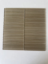Lux Bronze 12x12 flutted glass mosaic tile for wall installation by Roca, showcasing textured bronze glass surface.