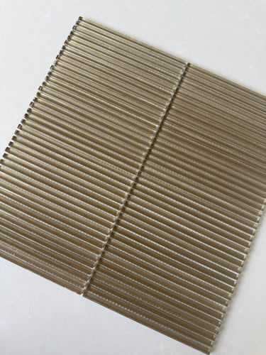 Lux Bronze 12x12 fluted glass mosaic wall tile by Roca, showcasing a textured bronze finish for modern backsplash designs.