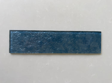 Roca LUX Indigo 3x12 glass tile wall featuring natural stone appearance, vibrant blue and indigo shades, sleek and modern design