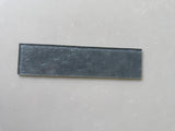 Lux Pewter 3x12 glass tile from Roca, a natural stone wall tile with a sleek, modern appearance and smooth glass surface.