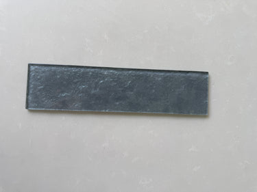 Lux Pewter 3x12 glass tile from Roca, a natural stone wall tile with a sleek, modern appearance and smooth glass surface.