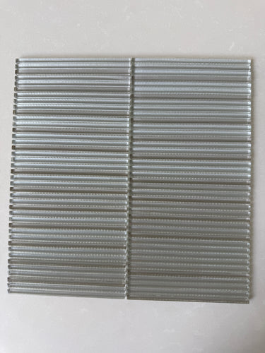 Lux Sand 12x12 glass mosaic featuring a dimensional linear pattern on a feature wall