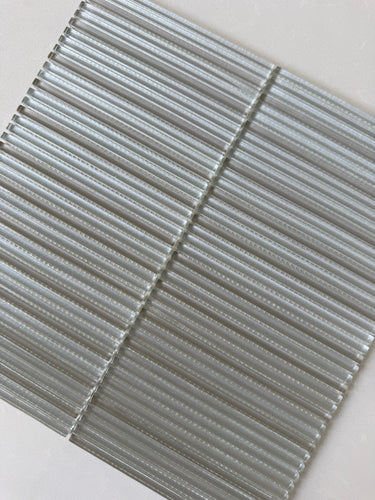 Roca Lux Sand 12x12 flutted glass mosaic tile for wall installation, featuring textured, sandy-colored glass surface.