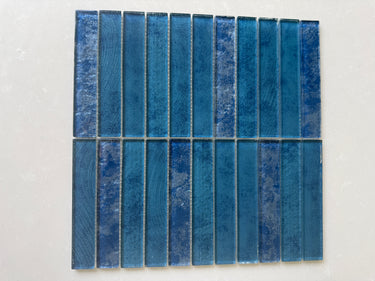 Natural sapphire 12x12 stacked mosaic tile by Roca, showcasing glossy glass and stone pattern for shower wall design.