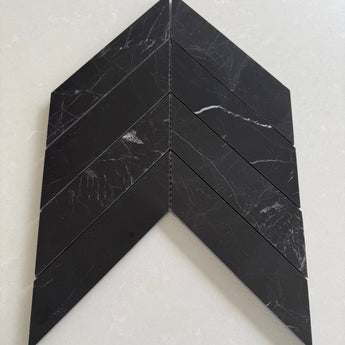 Nero Marquina polished 2x8 chevron marble mosaic tile with bold black stone and white veining