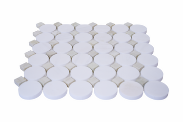 White marble mosaic tile with green dot accents and honed finish from Mythology Tile's Nestor series.