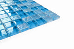 Crystal Aqua Osaka Sky Blue 1x1 glass mosaic tile installed on a bathroom shower wall with reflective glass surfaces and bright blue tones.