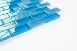 Crystal Aqua Osaka Sky Blue 1x2 glass mosaic tile installed on a bathroom shower wall with reflective glass surfaces and bright blue tones.