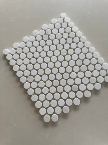 Polished Dolomite penny round marble mosaic installed on a luxury bathroom floor