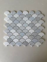 Roca Rockart blue mix Carrara Thassos fan-shaped 12x12 inch natural stone mosaic tile with blue, white, and gray tones.