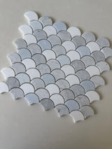 Roca Rockart Blue Mix Carrara Thassos fan-shaped mosaic tile for shower wall, featuring natural stone with blue, white, and gray tones.