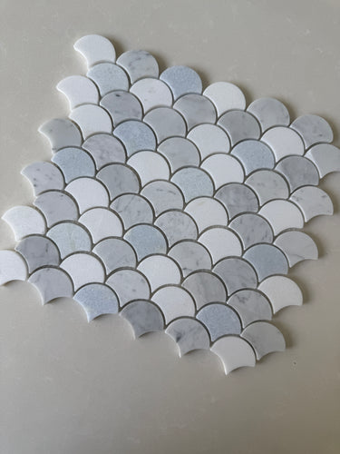 Roca Rockart Blue Mix Carrara Thassos fan-shaped mosaic tile for shower wall, featuring natural stone with blue, white, and gray tones.