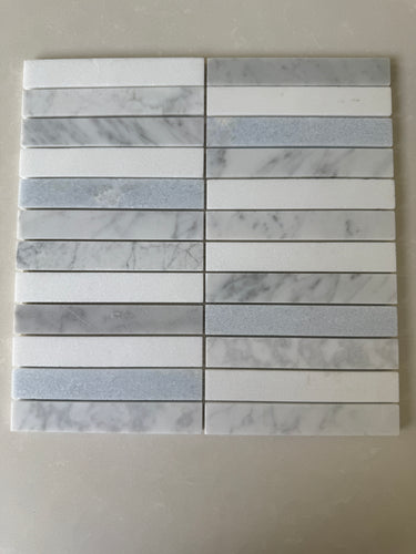 Blue Mix Carrara Thassos stacked mosaic installed on a sophisticated shower wall
