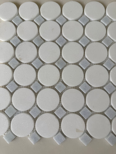 Natural stone tile by Roca featuring a blue mix Thassos circle mosaic for backsplash or wall decor, 12x12 inches.