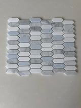 Natural stone tile from Roca's Rockart Blue Mix Thassos Picket mosaic, featuring blue and white Thassos stone for shower walls.
