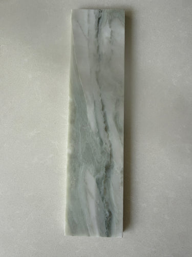 Green marble brick tile by Roca, natural stone 2x10 backsplash tile with elegant veining and smooth surface.