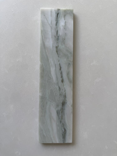 Polished green marble brick tile by Roca, natural stone 2x10 wall tile with elegant veining and glossy finish.