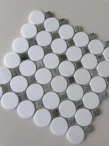 Natural stone tile mosaic featuring green mix Thassos circles by Roca, 12x12 inches, shown as a backsplash with circular pattern.