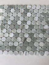 Green Mix penny round natural stone mosaic installed on a sophisticated shower wall
