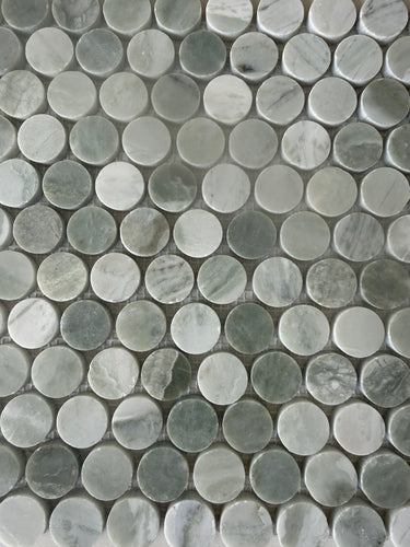 Green Mix penny round natural stone mosaic installed on a sophisticated shower wall
