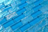 Crystal Aqua Osaka Sky Blue 1x2 glass mosaic tile used as a kitchen backsplash featuring a classic brick pattern and vibrant blue tones.