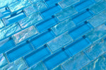 Crystal Aqua Osaka Sky Blue 1x2 glass mosaic tile used as a kitchen backsplash featuring a classic brick pattern and vibrant blue tones.
