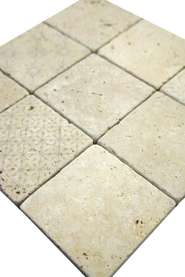 Close-up detail of decorative digital print on tumbled ivory travertine tile