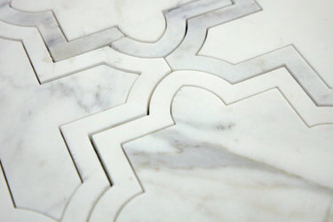 Close-up of honed white marble waterjet mosaic showing geometric detailing