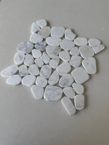 White Mix 11x11 natural stone pebble mosaic tile by Roca, showing a textured shower floor with smooth, rounded pebbles.