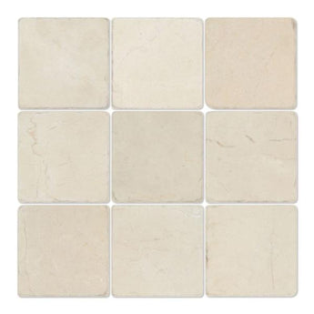 Four 4x4 tumbled Crema Marfil marble tiles, natural stone surface with warm beige tones, from MosaicBros.com