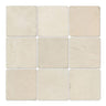 Four 4x4 tumbled Crema Marfil marble tiles, natural stone surface with warm beige tones, from MosaicBros.com