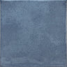Roca Olaria blue steel 2x6 bullnose wall tile showing a close-up of the textured blue ceramic surface