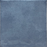 Roca Olaria blue steel 2x6 bullnose wall tile showing a close-up of the textured blue ceramic surface